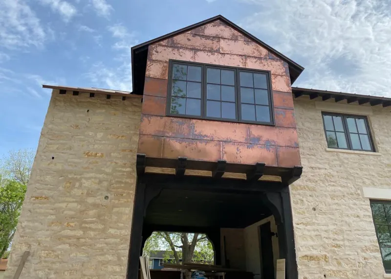 Copper metal panel facade on a stone building for Skylight Installation in Springboro
